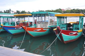 Fototapeta na wymiar Colorful tour boats moored along the river in Hoi An Vietnam