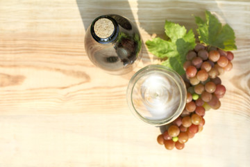 tasting a young wine/ green bottle clogged with cork on background of blurred outlines of glass and...