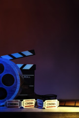Obraz premium Equipment and elements of cinema with dark blue background vertical