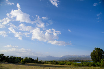 Clouds flying and soaring in the blue sky over the Tian Shan mountains