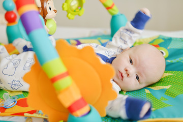  baby  on the  toy rug
