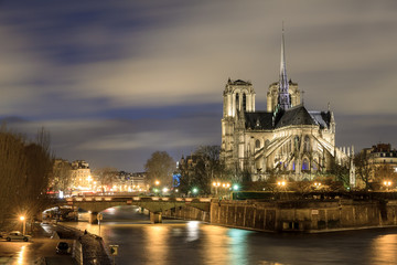 Beautiful view of the river Seine with the Notre-Dame Cathedral in Paris at night
