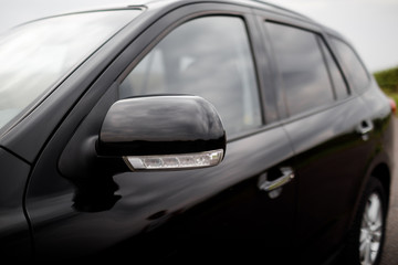 Details of black car. Door car - detail, car mirror close-up. 