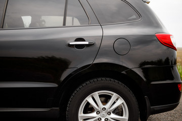 Obraz na płótnie Canvas Black modern car closeup. Black modern car headlights - front vi