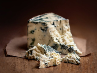 Blue cheese Gorgonzola on a rustic wooden background. Mold cheese with copyspace - obrazy, fototapety, plakaty