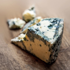 Blue cheese Gorgonzola on a rustic wooden background. Mold cheese with copyspace