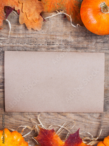 Thanksgiving Day Card With Orange Pumpkins And Colourful Leaves On Wooden Background With Blank Tag Paper Thanksgiving Day Card With Orange Pumpkins And Colourful Leaves On Wooden Background With Blank Tag Paper