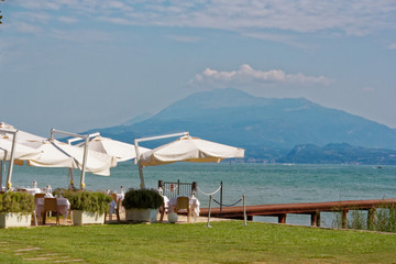 Sirmione, Italy 17 August 2018: Lake Garda. Cafe on the beach.