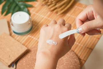 Woman applying moisturizing cream treatment Test cosmetic on hands.Beauty And Make-up Concept