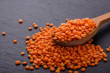 raw lentils on a dark stone background