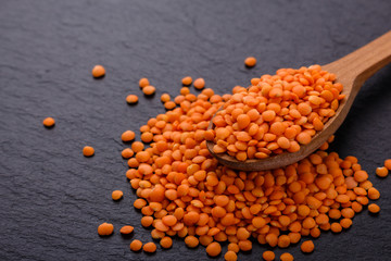 raw lentils on a dark stone background