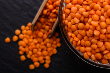 raw lentils on a dark stone background