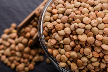 raw lentils on a dark stone background
