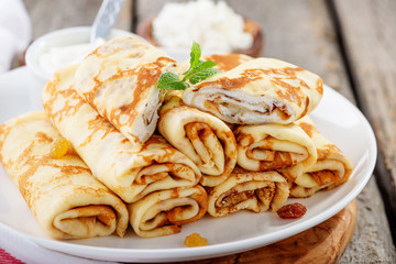 Thin pancakes stuffed with cottage cheese and raisins. 