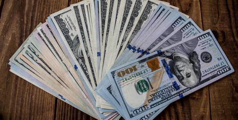 a dolor bills on a wooden background