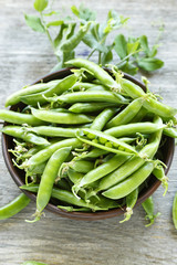 young peas on a wooden background