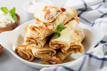Thin pancakes stuffed with cottage cheese and raisins. 