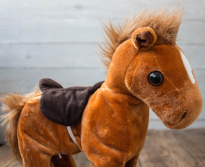 a beautiful red horse with a saddle kid toy