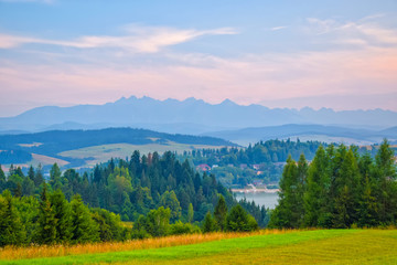 Rural landscape near artificial Czorsztynskie Lake in Southern Poland. High Tatra Mountains in background