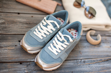 Sneakers, glasses, female handbag, hairpin and piece of jewelry - preparation for a travel