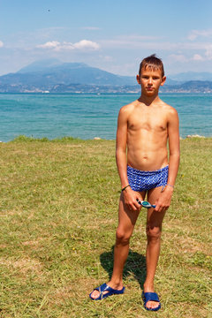 portrait of a teenager in swimming trunks on the beach. Stock Photo | Adobe  Stock