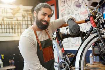 Man working in cycle repair shop