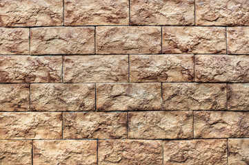 A wall of brown stone. Stone wall texture background natural color