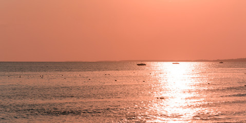 panorama sunset on the sea in pink. symmetric skyline