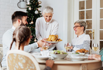 Family gathered over Christmas holidays, celebrating, having lunch 