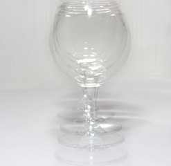A glass with water in different light and with its own copies like a shadow