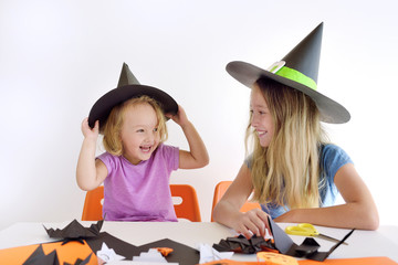 Two kids in carnival costumes for Halloween.