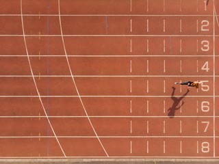 Female athletic running on sports track