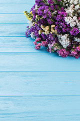 Limonium wedding bouquet, close up. Blue wooden table background.
