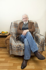 The old man in the armchair at home