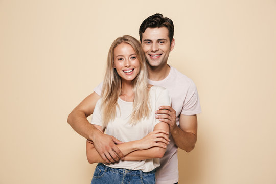 Portrait Of A Smiling Young Couple Standing Together