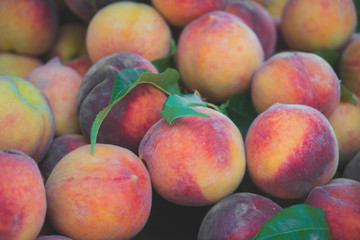 Lot of ripe peaches in the supermarket.