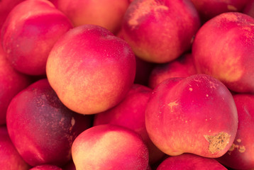 Lot of ripe nectarines in the supermarket.