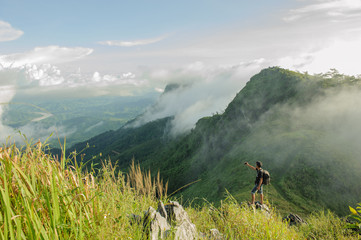 travel asian man taking mountain landscape photo at pha tang  tourist attraction in thailand