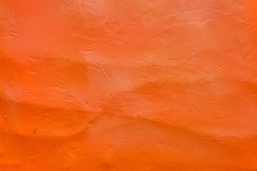 Rough concrete plaster is colored orange, texture for background.