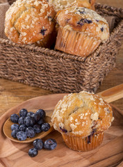 Blueberry Muffin and Spoonful of Berries on a Wooden Plate