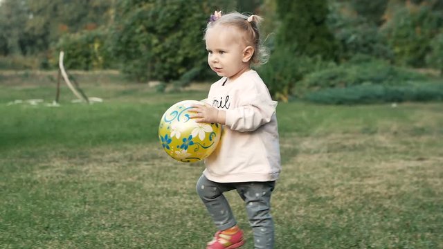 Mother And Daughter Play Ball In The Park