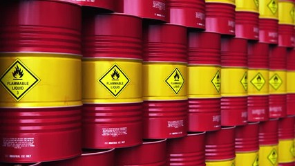 Group of rows of red stacked oil drums in storage warehouse