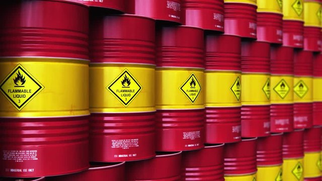 Group of rows of red stacked oil drums in storage warehouse