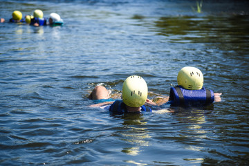 people in water in helmets and vests © Alexey Achepovsky