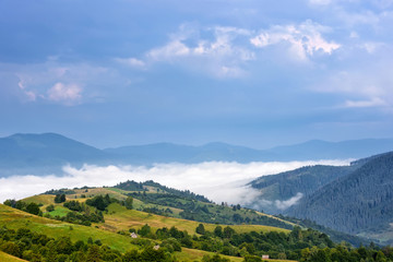 Fototapeta na wymiar Beautiful rural mountain landscape with fog in the valley. Carpathian, Ukraine, Europe.