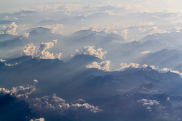 Fototapeta na wymiar White clouds over the mountains