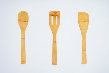top view of arranged wooden kitchen utensils isolated on grey
