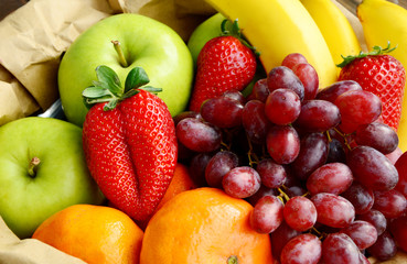 5 kind fresh  fruits in brown paper bag.
Mixed and colorful of fruits.