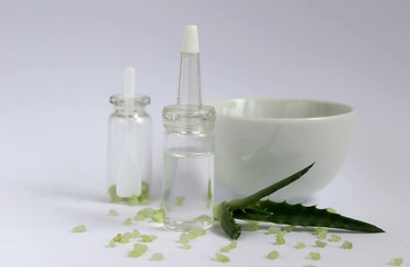 Essential oil for beauty. Cosmetic ingredients and aloe stand on a light background 