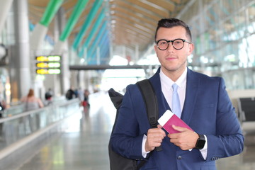 Elegant passenger holding passport and boarding pass at the airport